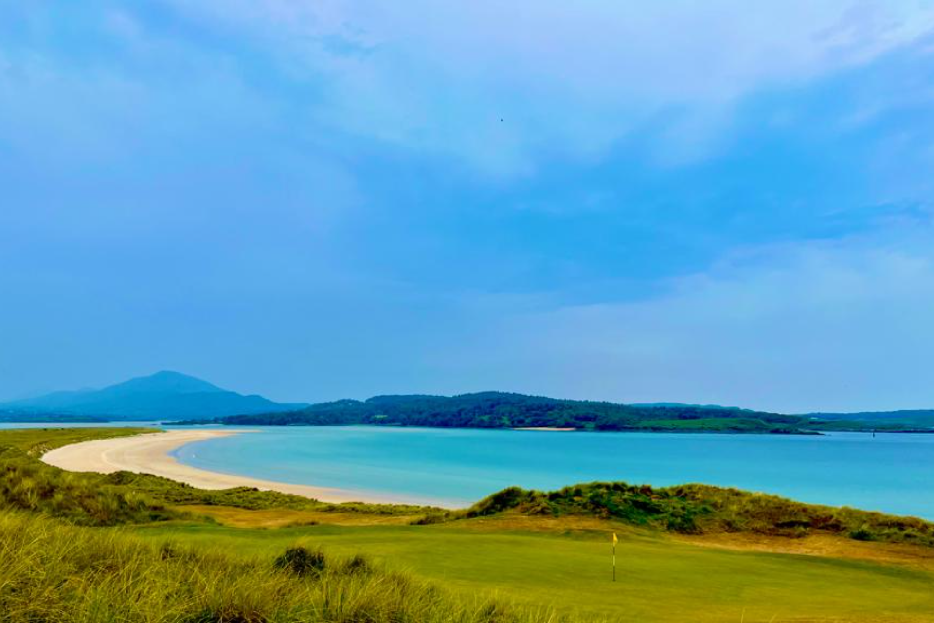 Links golf course beside a sandy bay in Donegal